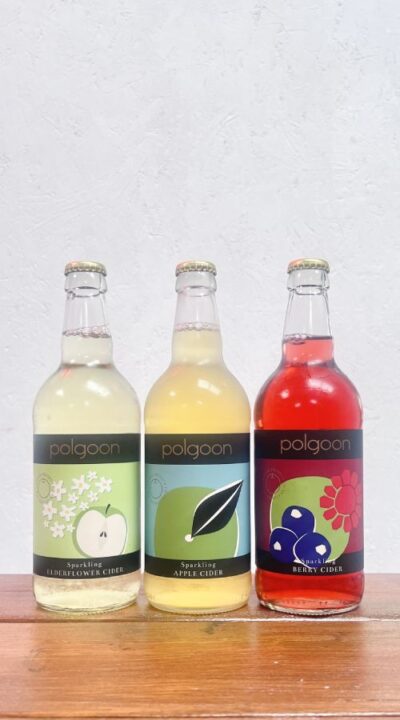 Three bottles of cider from Polgoon Vineyard in Cornwall. This includes an original apple cider, an elderflower and apple cider and a berry and apple cider.